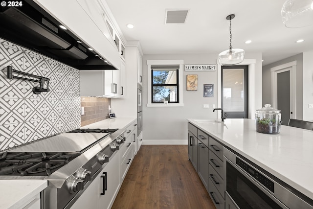 kitchen featuring sink, decorative light fixtures, ventilation hood, decorative backsplash, and white cabinets