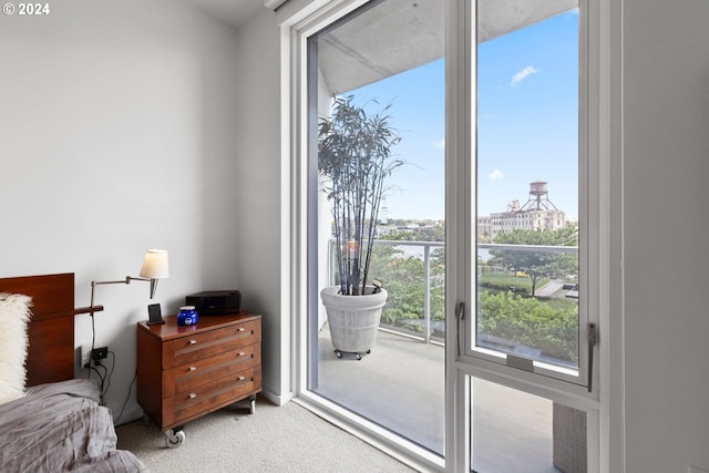 bedroom featuring access to outside and light carpet