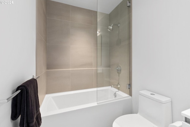 full bathroom with toilet and shower / bath combination with glass door