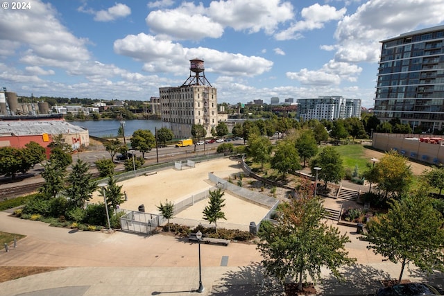 view of water feature featuring a view of city and fence