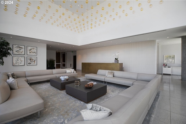 living area with a towering ceiling and recessed lighting