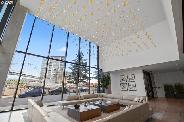 living room featuring a high ceiling and tile patterned flooring