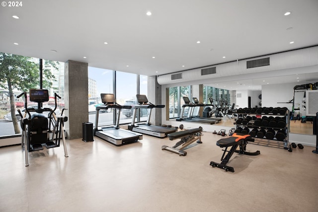 gym with a wall of windows, visible vents, and plenty of natural light