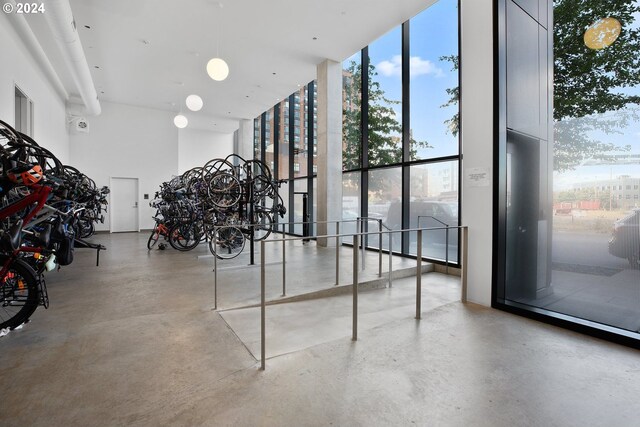 interior space featuring a high ceiling and floor to ceiling windows