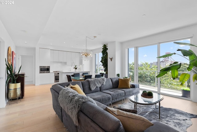 living room featuring a chandelier and light hardwood / wood-style floors