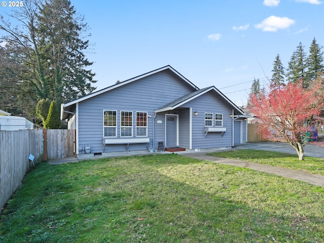 view of front of property with a garage and a front lawn