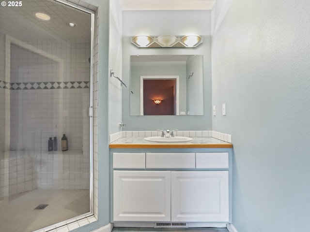 bathroom with vanity and walk in shower