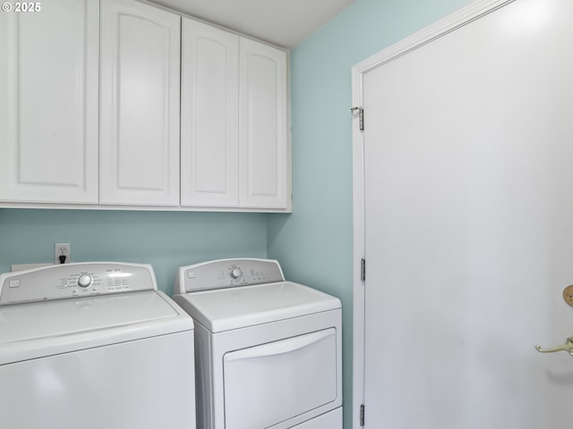 washroom with cabinets and separate washer and dryer