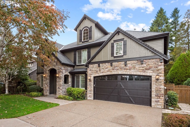 view of front of house featuring a front lawn and a garage