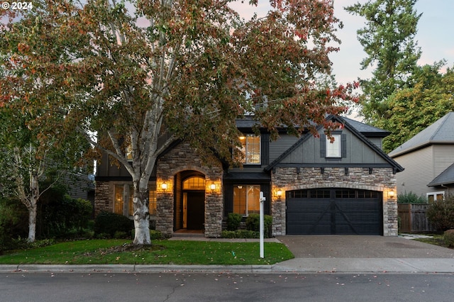 view of front of house with a garage and a lawn