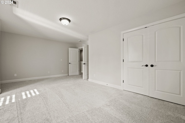 unfurnished bedroom featuring a closet and carpet floors