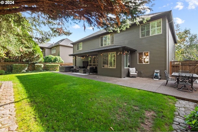 rear view of house with a patio area and a lawn