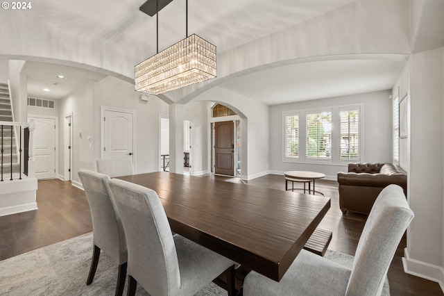 dining space with an inviting chandelier and dark wood-type flooring