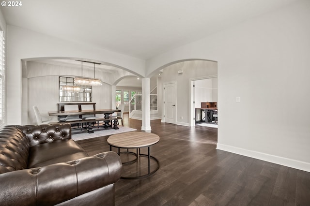 living room featuring hardwood / wood-style flooring and an inviting chandelier