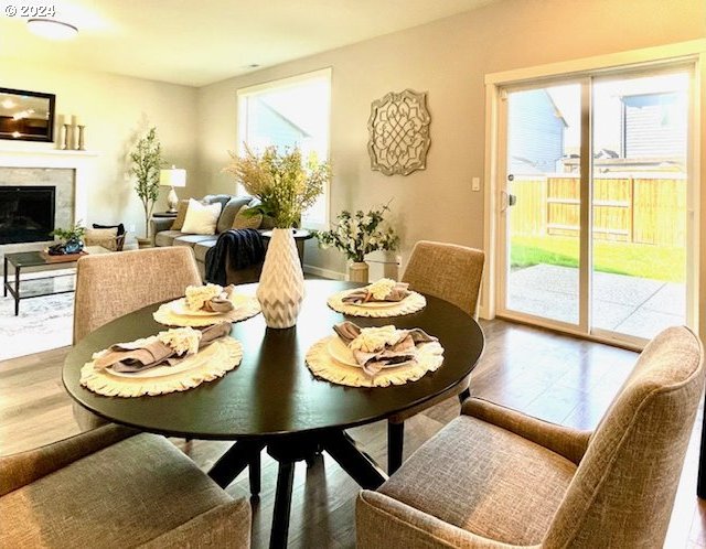 dining space with wood-type flooring