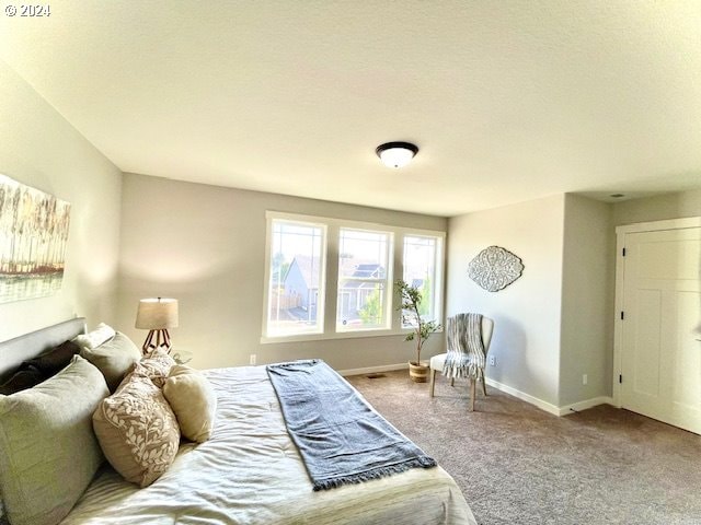 bedroom featuring carpet and a textured ceiling