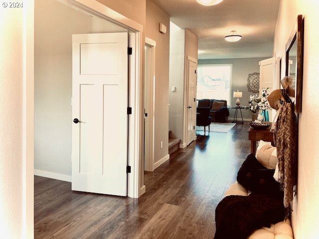 corridor with dark hardwood / wood-style flooring