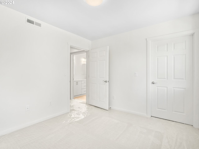 unfurnished bedroom with light carpet