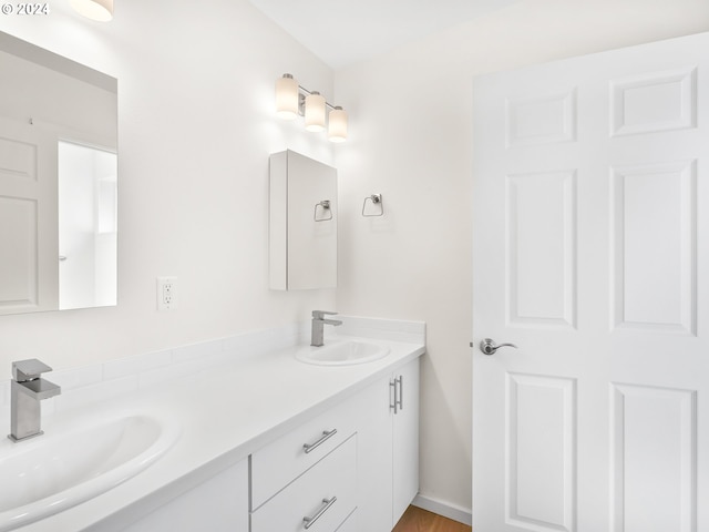 bathroom with vanity and wood-type flooring