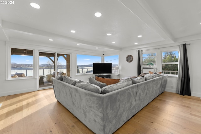 living room featuring light wood-type flooring and beamed ceiling