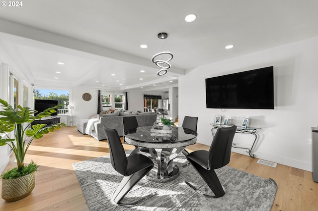 dining room with a chandelier and light hardwood / wood-style flooring