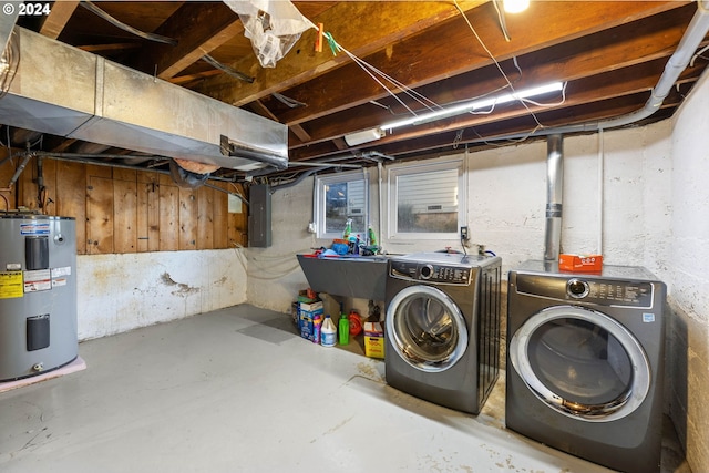 basement featuring sink, washing machine and dryer, and electric water heater