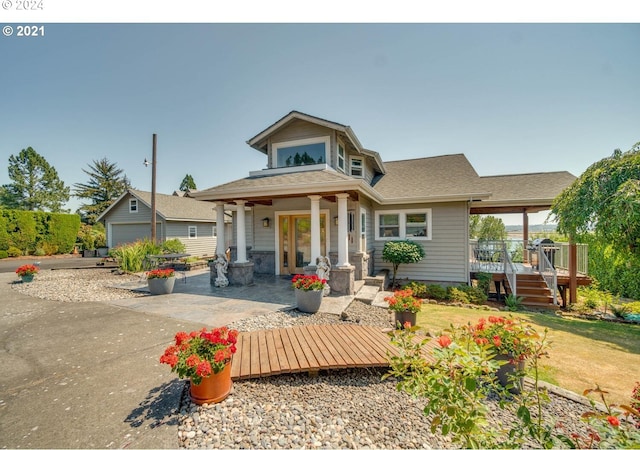 back of property featuring a wooden deck and a yard