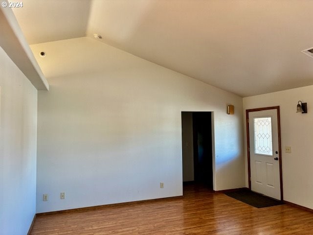 foyer entrance featuring vaulted ceiling and hardwood / wood-style floors