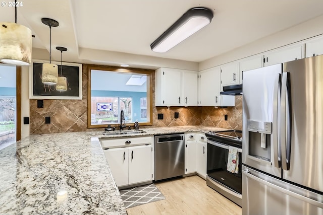 kitchen featuring white cabinetry, sink, hanging light fixtures, and appliances with stainless steel finishes