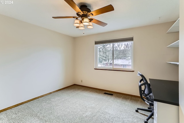 unfurnished office featuring ceiling fan and carpet floors