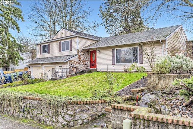 tri-level home with a garage and a front yard