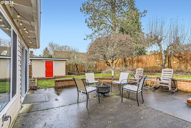 view of patio / terrace with an outdoor structure and a fire pit