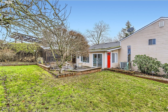 rear view of house featuring a lawn and a patio area