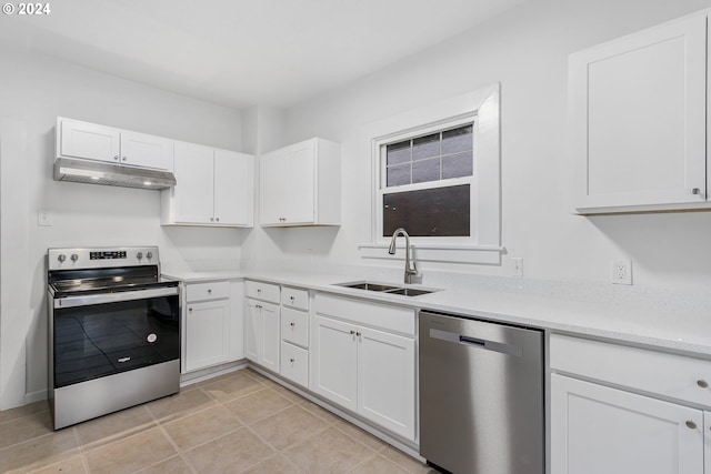 kitchen with sink, light tile patterned floors, white cabinets, and appliances with stainless steel finishes