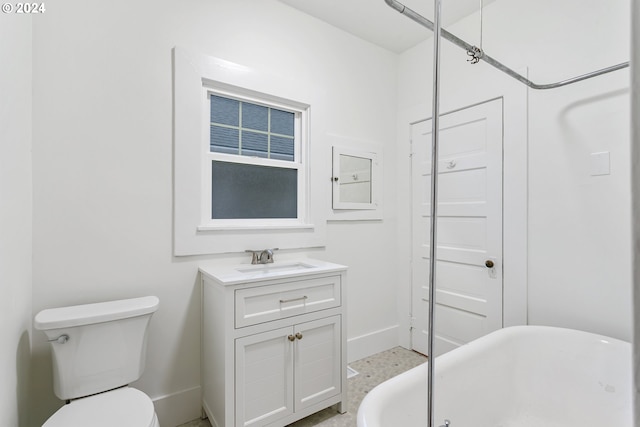 bathroom with vanity, toilet, and a bathing tub