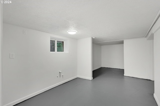 basement featuring a textured ceiling