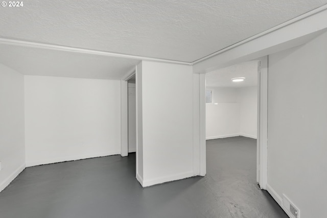 basement featuring a textured ceiling