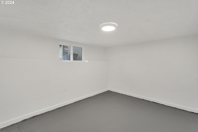 basement featuring a textured ceiling