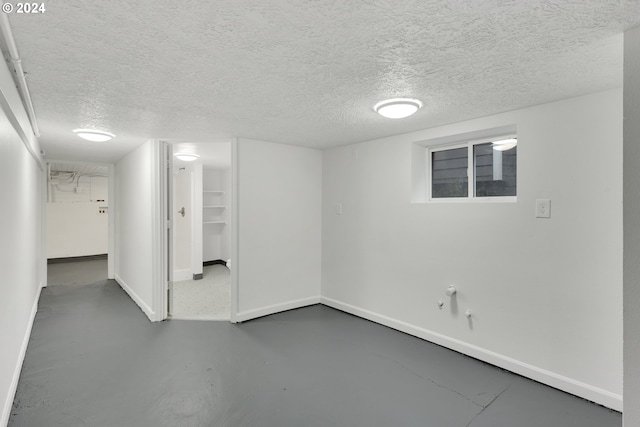 basement featuring a textured ceiling