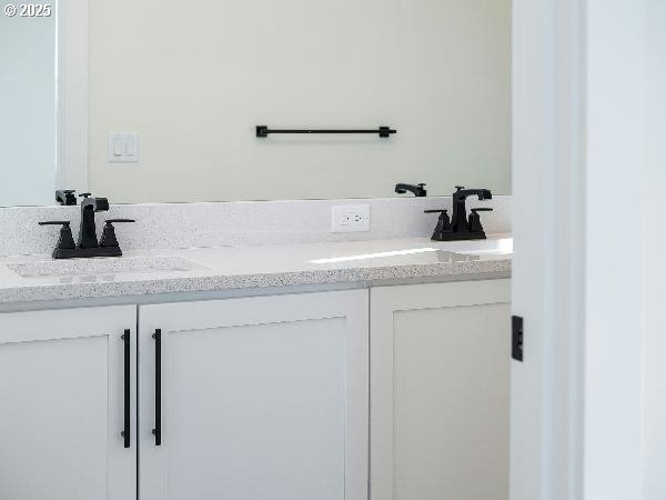 full bathroom featuring double vanity and a sink