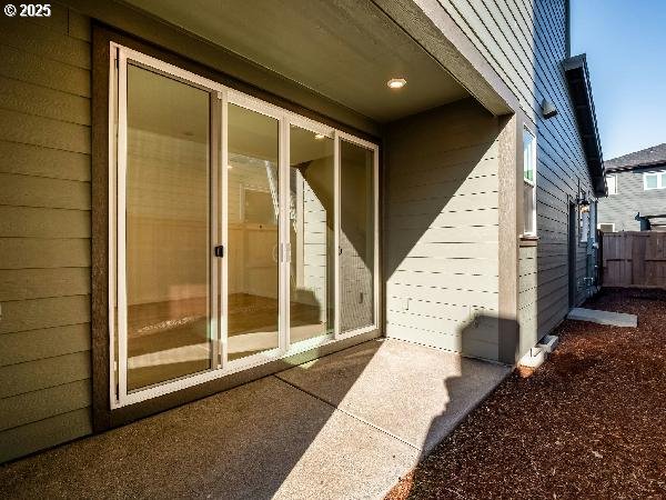 view of exterior entry with fence