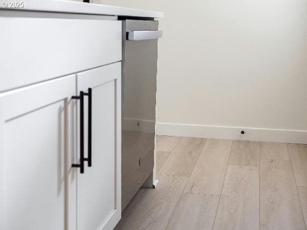 room details featuring baseboards and wood finished floors