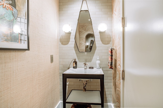 bathroom with tasteful backsplash and a sink