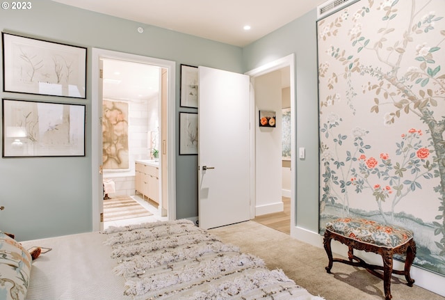 bedroom with light carpet, connected bathroom, and recessed lighting