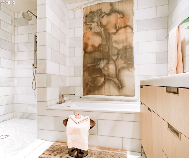 bathroom featuring a tile shower and a bath