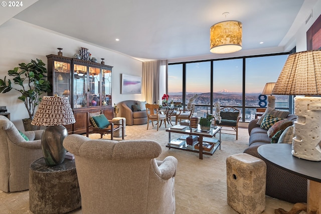 carpeted living area with expansive windows and recessed lighting