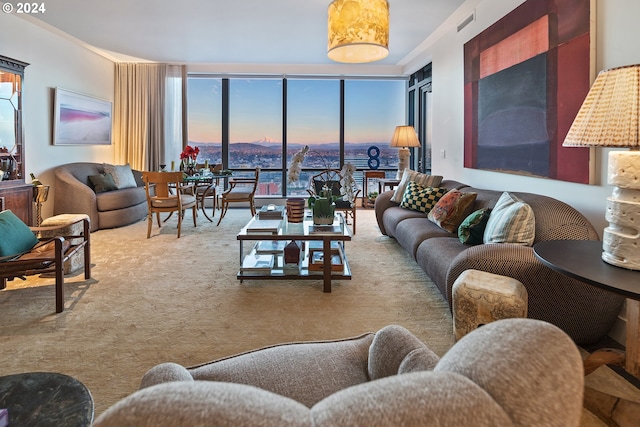 carpeted living area with visible vents and a wall of windows