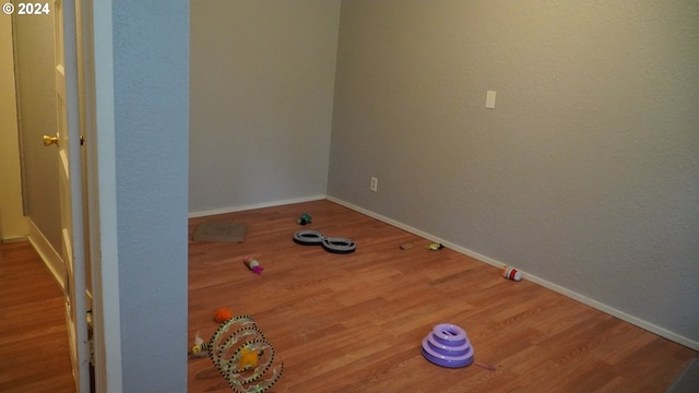 unfurnished room with hardwood / wood-style floors