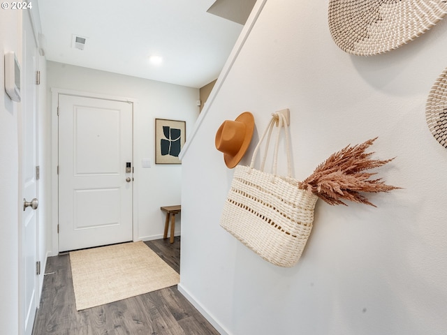 entryway with a notable chandelier and dark hardwood / wood-style flooring