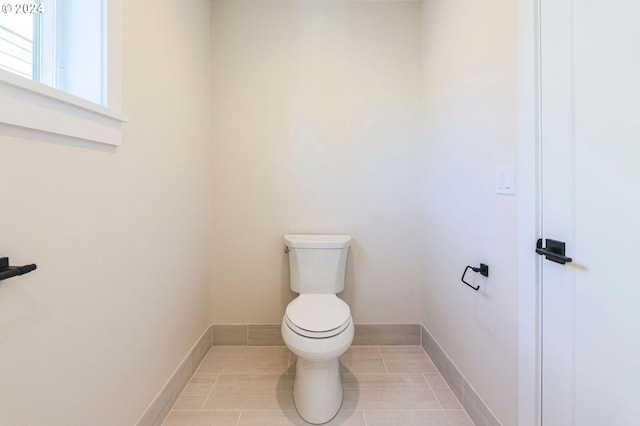 bathroom with tile patterned flooring and toilet